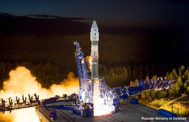 A Soyuz rocket lifts off on a column of flame at night from a launch pad at Plesetsk, Russia.
